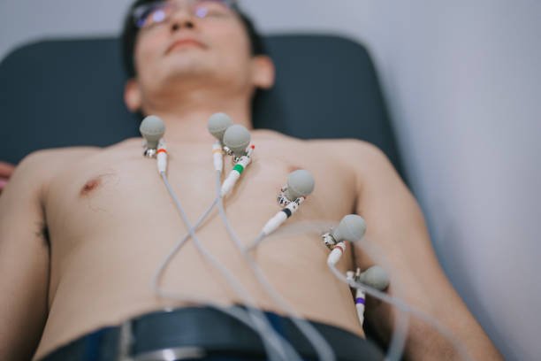 asian chinese male patient electrocardiogram exam at hospital asian chinese male patient electrocardiogram exam at hospital