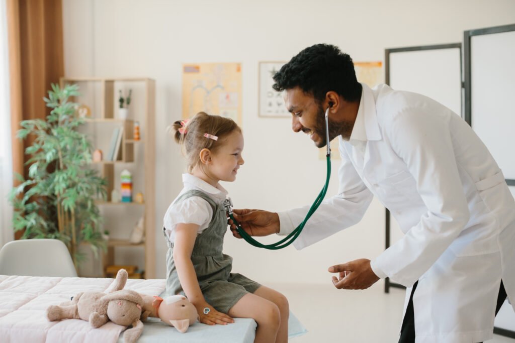 the doctor listens to the lungs of a minor patient with a stethoscope. the concept of a children's doctor.